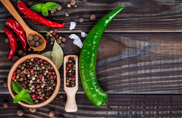 Powder spices on spoons in black wooden table background