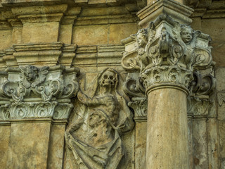 skull and bones ornaments on an old cemetery. Concrete death themed tomb decorations