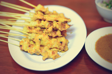 Grilled pork served with peanut sauce or sweet and sour sauce