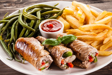 Wrapped pork chop, chips and vegetables 