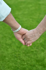 Elderly couple holding hands