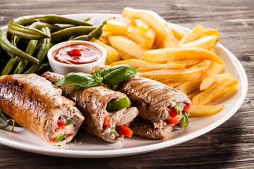 Wrapped pork chop, chips and vegetables 