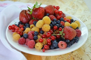 Summer berries on the white plate 