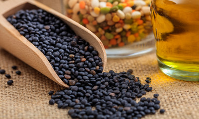 Wooden scoop with black lentils