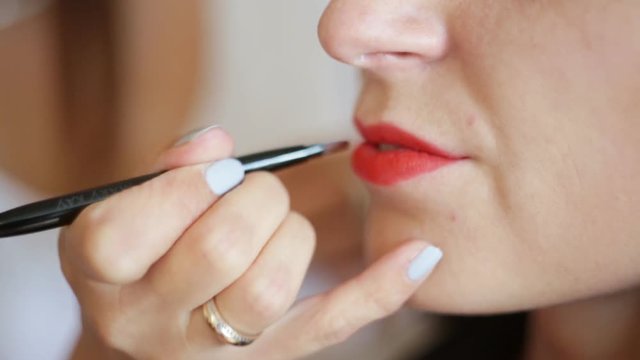 professional makeup artist paints a model lips,makeup, professional makeup