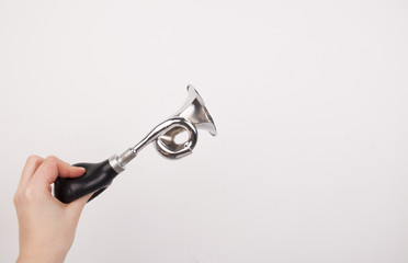 Hand holding the vintage manual air horn on white background.