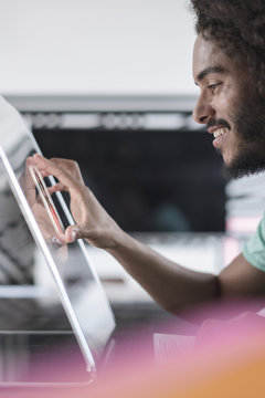 Young man working ion futuristic computer