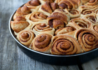 cinnamon buns on wooden surface