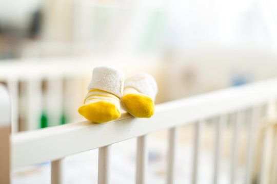 baby booties on a cot crib for infants