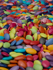 Fototapeta na wymiar Plenty of colorful chocolate tabs close-up for designer