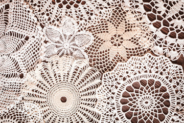 Beautiful delicate vintage lace background of crochet napkins on the table