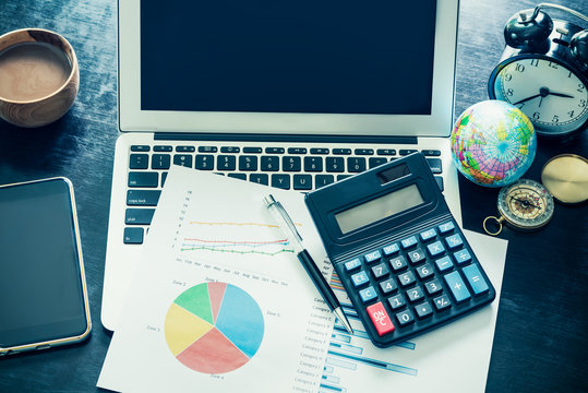 Business document with charts growth,laptop, mobile phone, calcu