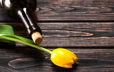 Tulip and wine on wood