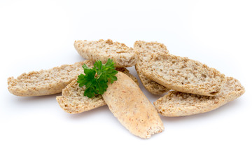 Dry flat bread crisps with herbs on a white background.
