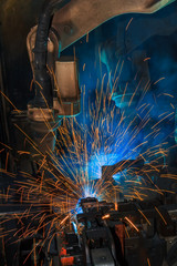 Lighting from robots welding steel.