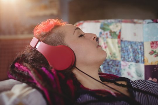 Hipster woman listening music at home