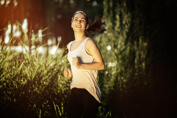 Athletic woman jogging in nature