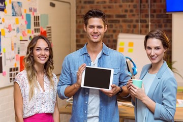Business people standing with a digital tablet