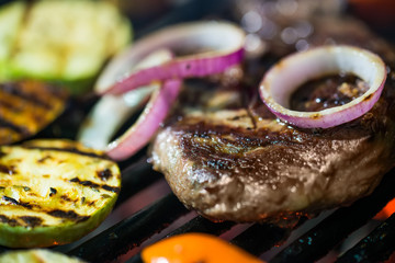 Beef steaks on the grill with flames