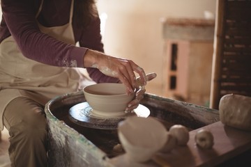 Male potter making bowl