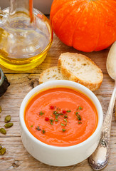 Pumpkin cream soup with thyme and pink pepper. Delicious healthy lunch
