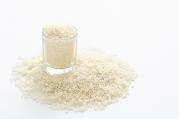 basmati rice in a small cup isolated on white background.