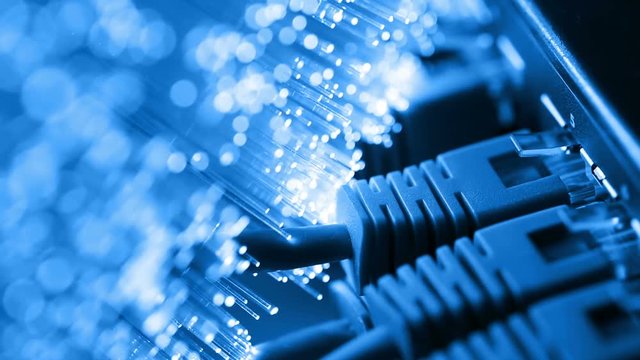 Ethernet cable and server with Fiber optics background, shot in HD