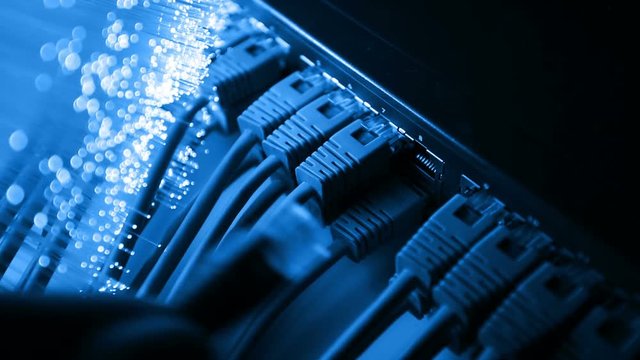 Ethernet cable and server with Fiber optics background, shot in HD