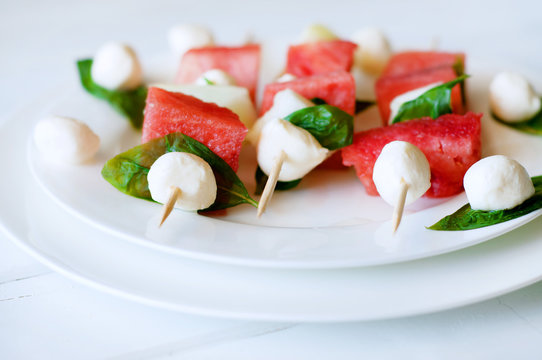 Watermelon kebab with spicy sauce, basil and mozzarella cheese