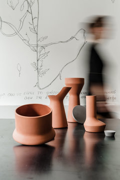 Ceramics on table against of female silhouette