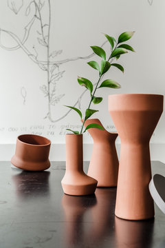 Different ceramic vases on table