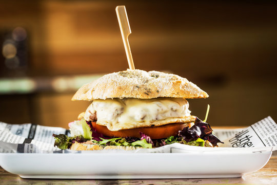 Delicious burger with beef and cheese on metal plate