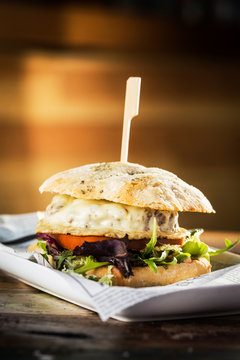 Delicious burger with beef and cheese on metal plate