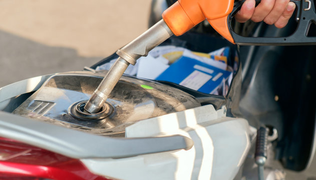 Refuel / View of motorcycle refueling at petrol station.