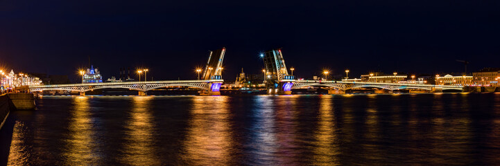 Fototapeta na wymiar Night panoramic view on illuminated open Blagoveshchenskiy Bridge and Neva River, St. Petersburg, Russia.