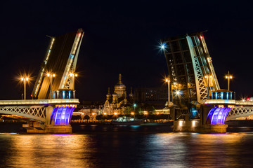 Fototapeta na wymiar Night view on illuminated open Blagoveshchenskiy Bridge, Neva River and Assumption Church on Vasilyevsky Island, St. Petersburg, Russia.