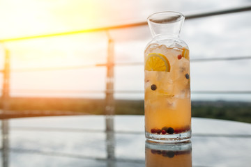 fresh summer sangria cocktail with lemon and berries;