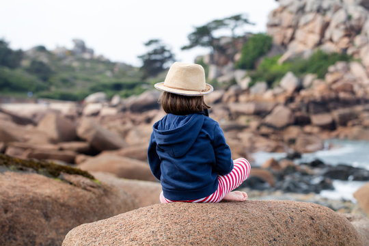 Lonely Child Sitting On Backside For Boredom, Freedom Or Sadness