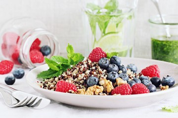 Quinoa salad with fresh berries,walnuts and mint lime honey Dressing.Superfoods and clean eating concept.
