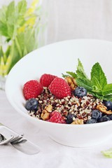 Quinoa salad with fresh berries,walnuts and mint lime honey Dressing.Superfoods and clean eating concept. 