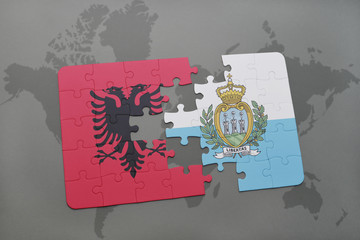 puzzle with the national flag of albania and san marino on a world map background.