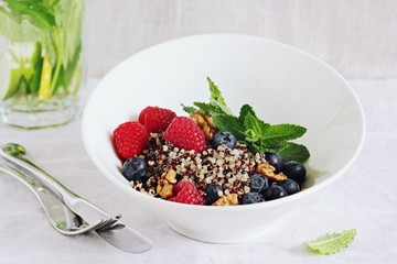 Quinoa salad with fresh berries,walnuts and mint lime honey Dressing.Superfoods and clean eating concept. 