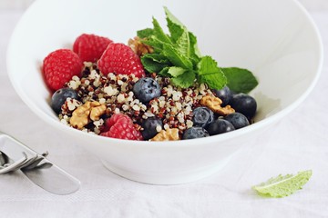Quinoa salad with fresh berries,walnuts and mint lime honey Dressing.Superfoods and clean eating concept. 
