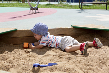 Kid crawling in sandbox