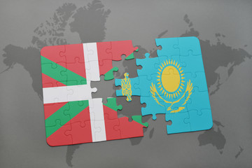 puzzle with the national flag of basque country and kazakhstan on a world map background.