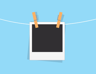 Single blank photo hanging from string
