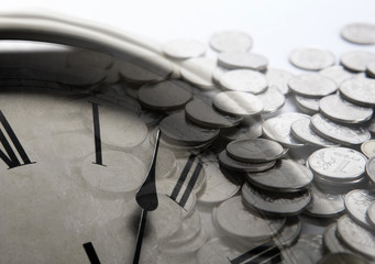pile of coins with clock face