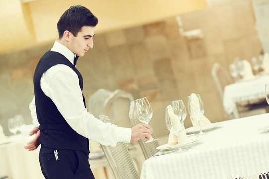 Waiter Man Serving Banquet Table At Restaurant