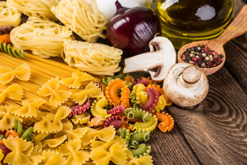 The composition of the pasta and vegetables on a wood background