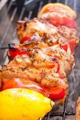 Close-up of a chicken shawarma kebab cooking on a on a barbecue